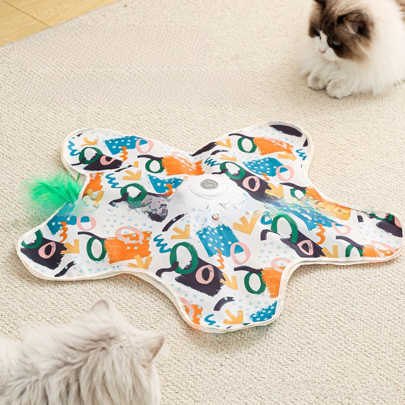 Colorful catnip toy shaped like a fish on a carpet with cats interacting.
