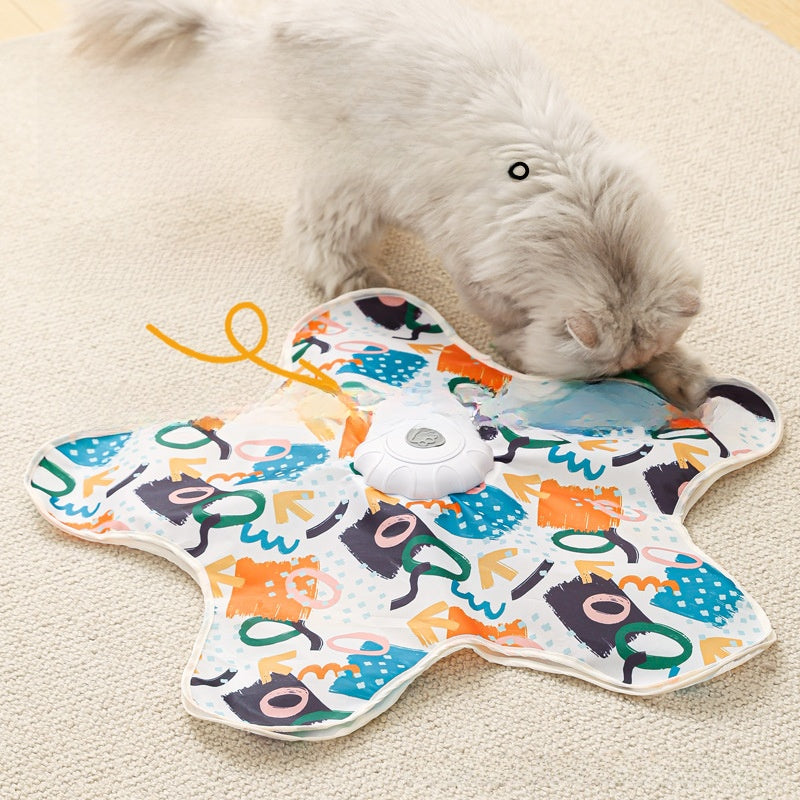 Colorful butterfly-shaped toy with a small white dog interacting with it on a beige carpet.